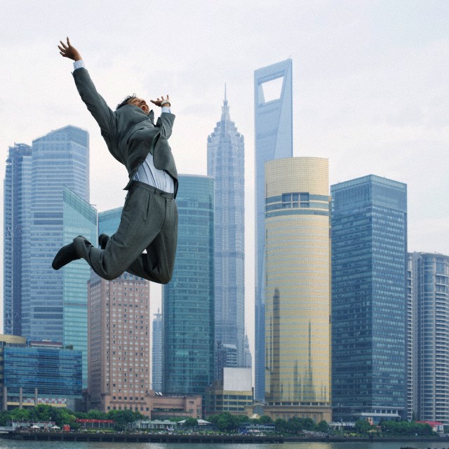 business man leaping in Shanghai, China